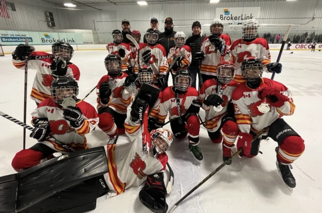 Coniston Flames hockey team celebrating on the ice